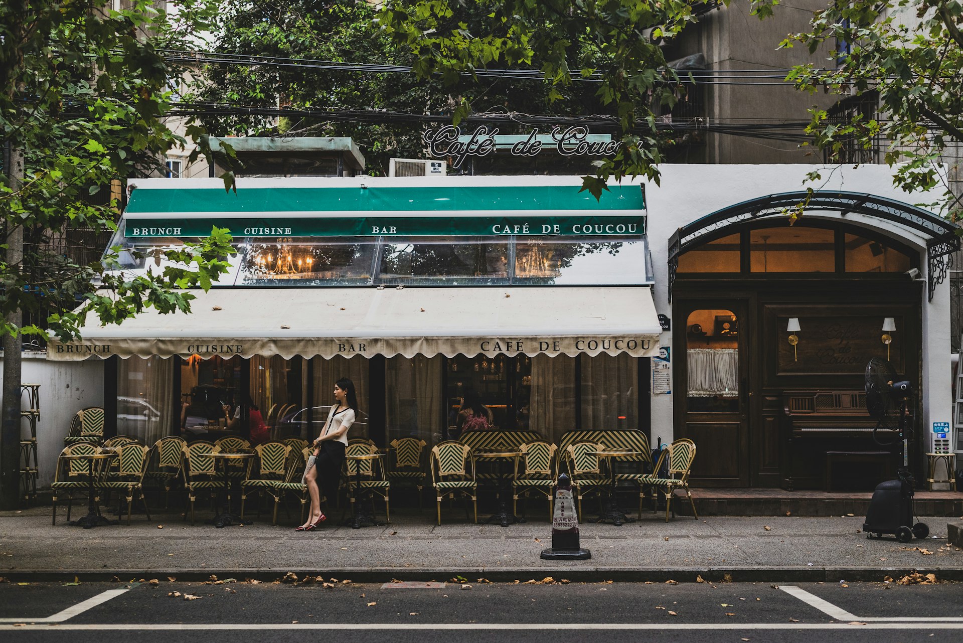 people sitting on bench near store during daytime